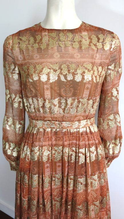 Vintage MOLLIE PARNIS Metallic gold floral jacquard silk dress.  The base silk chiffon is printed with a highly detailed floral artwork in shades of beige to golden amber.  The metallic gold, floral jacquard repeats as a horizontal banding, and is