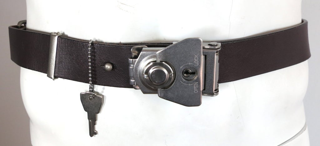 Vintage MATSUDA JAPAN leather lock and key belt.  Dark brown leather belt with retractable, locking buckle.  The buckle does not require the attached key to open, but can be locked.  The front hardware twists open revealing the inside hardware