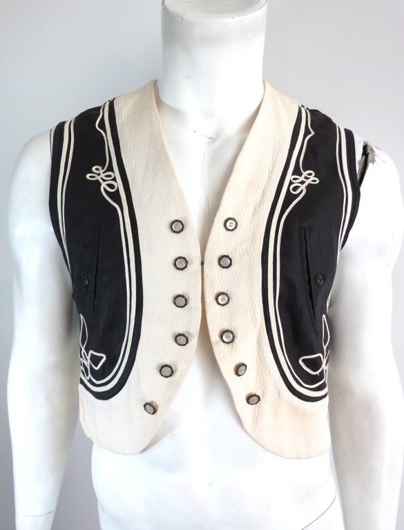 Vintage MATSUDA JAPAN 1980's soutache detail cropped bolero vest. The vest features stitched down soutache detailing at front and back with novelty, engraved metal buttons at front.  Single hook and eye closure at front.  Unisex garment which can be