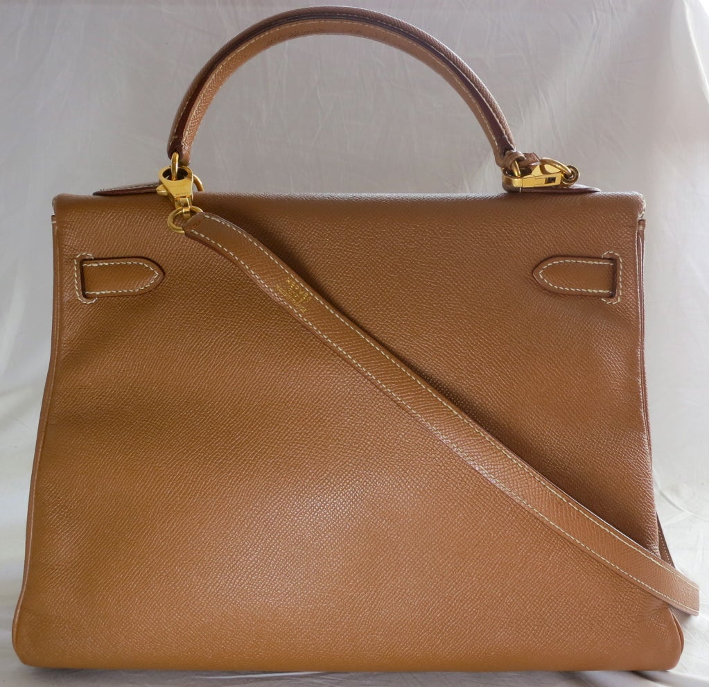 HERMES PARIS 32cm Tan leather gold hardware Kelly bag .  In excellent condition with no damages or wear inside or out.  The bag includes detachable shoulder strap, two keys with corresponding lock.