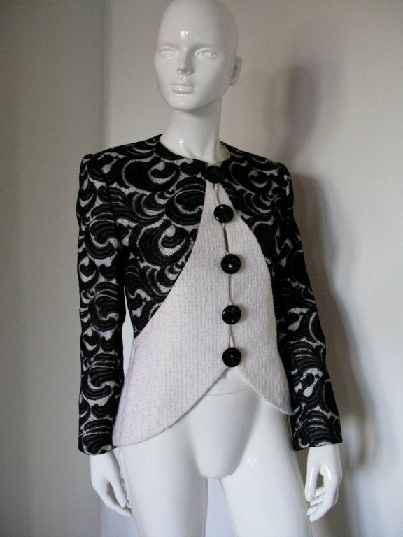 Vintage GALANOS 1980's Black lace & ivory boucle jacket.  The sleeves and shoulder panels are constructed of black lace overlay, atop the main boucle fabric.  Fully lined, with A panel back.  

Underarm to underarm: 36