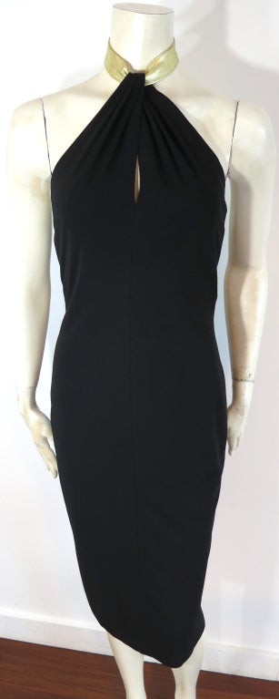 HALSTON Black matte jersey halter dress with metallic gold leather neckband.  Draped, keyhole style front with leather buckle closure at back neck.  Concealed, center back zipper entry.  Fully lined.

Underarm to underarm: 13-/2