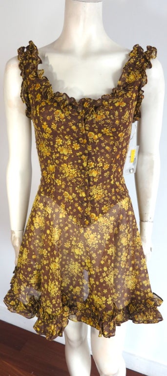 Vintage/Unworn PARAPHERNALIA by Betsey Johnson 1960's era floral dress still with the original tag and spare button bag.  Ruffle construction detail at neckline, and hem.  Self fabric covered button front closures with a fitted waist