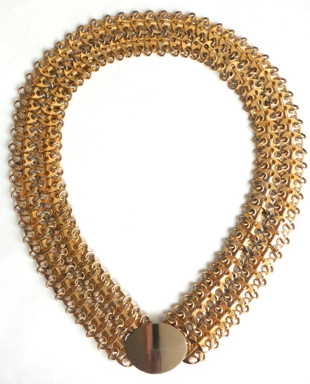 Vintage PACO RABANNE Gold finish chain mail belt with oval shaped front.  Hook to ring closure beneath front oval plate.  

Inside circumference when belt is closed: 34