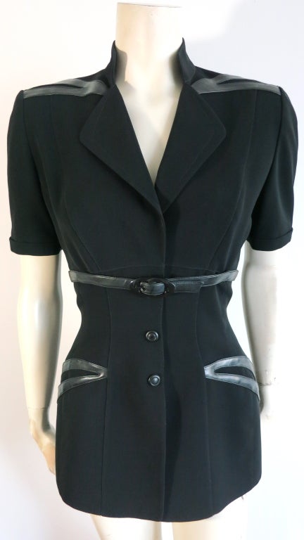Vintage THIERRY MUGLER 1980's era Black leather trim jacket with belted waist detail.  Short sleeve silhouette jacket with soft leather appliques at shoulders and waist.  Triple leather covered snaps at front.  Stretch fabrication.  Fully lined. 