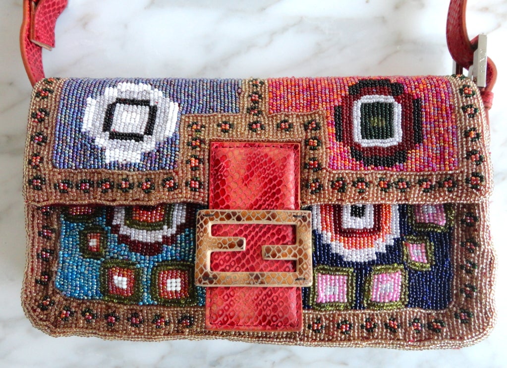 FENDI Geometric floral hand beaded red python baguette purse.  Engineered geometric patterning at the front, back, and sides with border detail.  Python front logo plate with snap down closure.  Adjustable, logo engraved polished silver side buckle