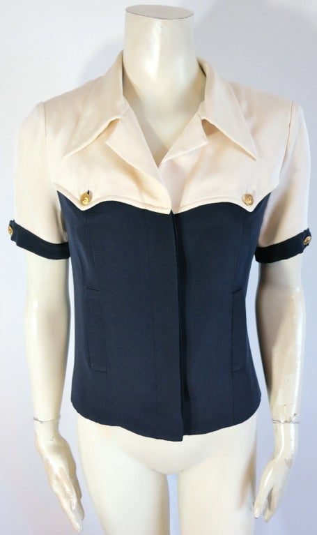 Vintage CHANEL PARIS 1980's Ivory & midnight silk button down top.  The top functions more like a short sleeve jacket, as the bodice is lined in solid silk, and there are functioning pockets at the bottom front bodice.  The bottom hem is weighted