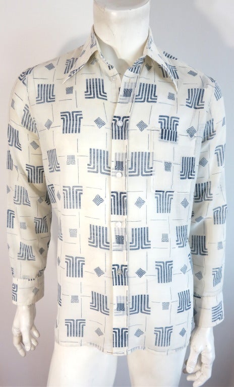 Vintage LANVIN PARIS 1970's Logo printed shirt.  The fabric base is a semi-sheer, ivory cotton blend with an all-over, indigo printed monogram logo in a grid pattern. Monogram logo engraved, pearl button closures.  Left chest patch pocket detail. 