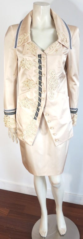CHRISTIAN LACROIX Luxurious, silk satin skirt suit featuring detailed french knots, and soutache detail appliques.  Single, jet-black crystal beading at top of cuffs, collar, and appliques at the wearer's right/front panel. Striped rib knit trim at