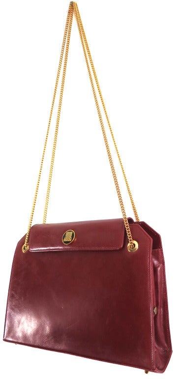 Vintage LANVIN PARIS 1970's era burgundy leather purse with gold finish metal chain straps.    Circle logo front snap head at top flap closure.  Triple internal compartments including internal clasp top opening with zipper storage pouch.  Lined in