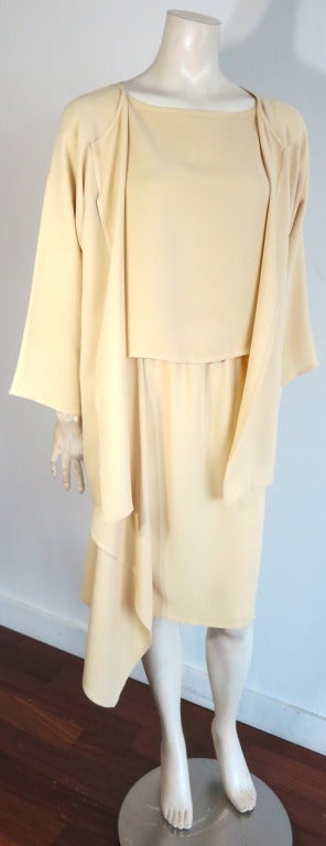 Gorgeous ZORAN pure silk 3pc. cascade skirt ensemble in light yellow crepe.  The set includes boat neck style blouse, cascade detail skirt, and open front jacket.  The skirt features an elastic waistband for a flexible fit.  Loose fit silhouette