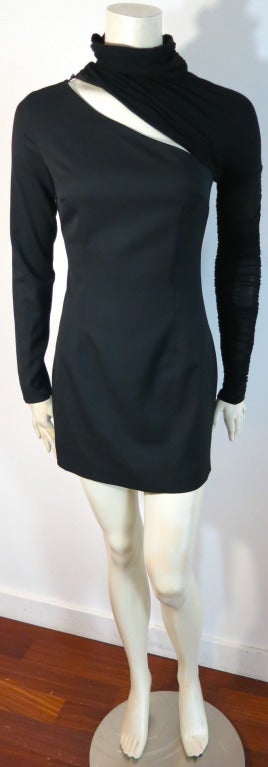 New with tags PIERRE BALMAIN shirred knit sleeve and turtle neck dress with front to back cut out detail.  The main dress is made of solid virgin wool, and features a button off/on knit wool turtle neck and sleeve.  The sleeve features a shirred