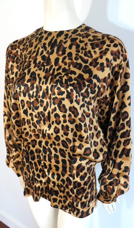 Vintage YVES SAINT LAURENT Leopard printed silk blouse.  Luxurious hammered silk fabric base with leopard artwork overprint.  Smoked pearl button closures at rear placket entry.  'V' shaped seaming construction at the front chest with a blouson