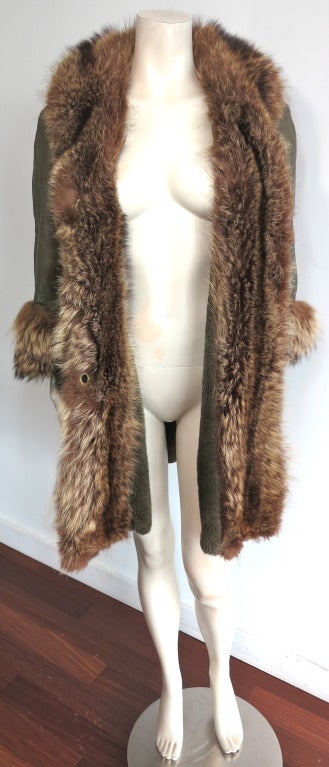 Vintage BONNIE CASHIN / SILLS 1960's olive, Angola leather & raccoon fur coat.  Signature dual, brass metal, turnlock closures at front with oversized front, waist level flap pockets.

Luxurious raccoon cuffs, front opening, and internal placket