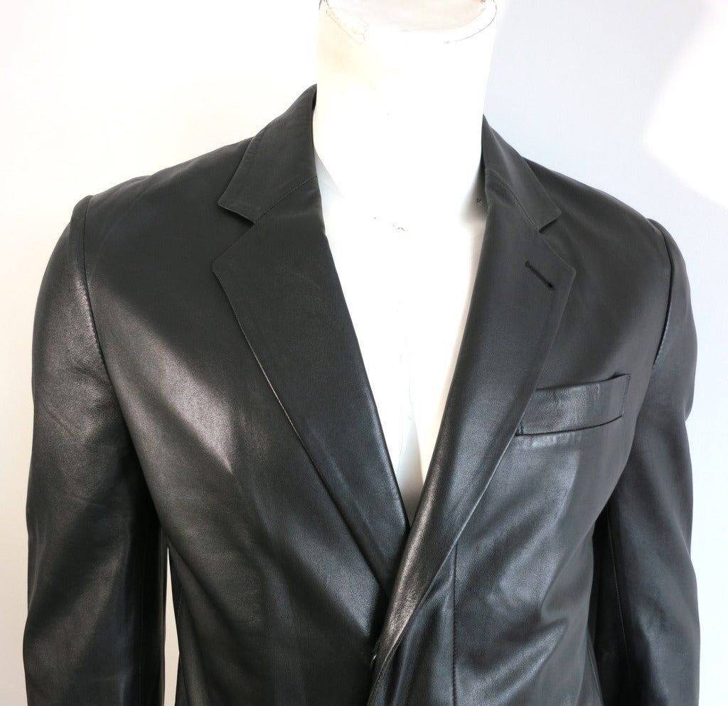 HELMUT LANG 1990's Black italian leather coat.  Concealed front placket design with dual waist flap pockets.  SIngle back vented construction.  Functioning, surgeon style sleeve cuffs.  Inside center back neck locker loop detail

Fully