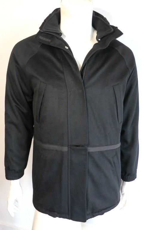 Luxurious LORO PIANA ITALY 100% Cashmere, black 'Icer' model coat originally designed for 2000 winter olympics.

Ultra-soft cashmere that has a luxurious sheen when reflected in the light.

Storm front placket design with both logo engraved