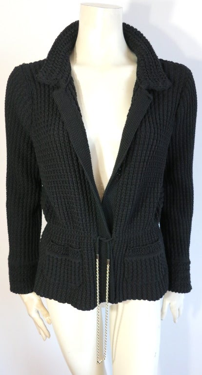 CHANEL Black sweater knit jacket with chain detail waist.

The jacket was only worn once, and is in 'like new' condition, with absolutely no signs of wear or damages.

Thick sweater knit fabrication with fashioned lapel and collar.

Dual waist