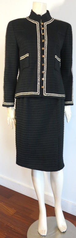 Vintage CHANEL 1980's era Black & ivory zig-zag stitch skirt suit.

The base fabric is a thick, ribbed wool/mohair weave with black, zig-zag stitched ivory stripe border detailing.  The interior jacket outer edges, as well as the kick-pleat of the