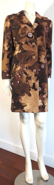 MOSCHINO COUTURE! Autumn foliage, photographic printed coat.  The coat features a lovely digital printed wool fabrication of layered leaves and japanese style florals.

Four wooden button front closures with twin buttons at cuffs.

Angled, welt
