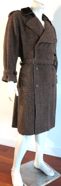 Vintage GUCCI 1970's era herringbone tweed coat with matching belt

Double breasted front with leather, logo engraved button closures

Faux fur top collar with genuine leather underside at belt

Adjustable sleeve belted detailing with button