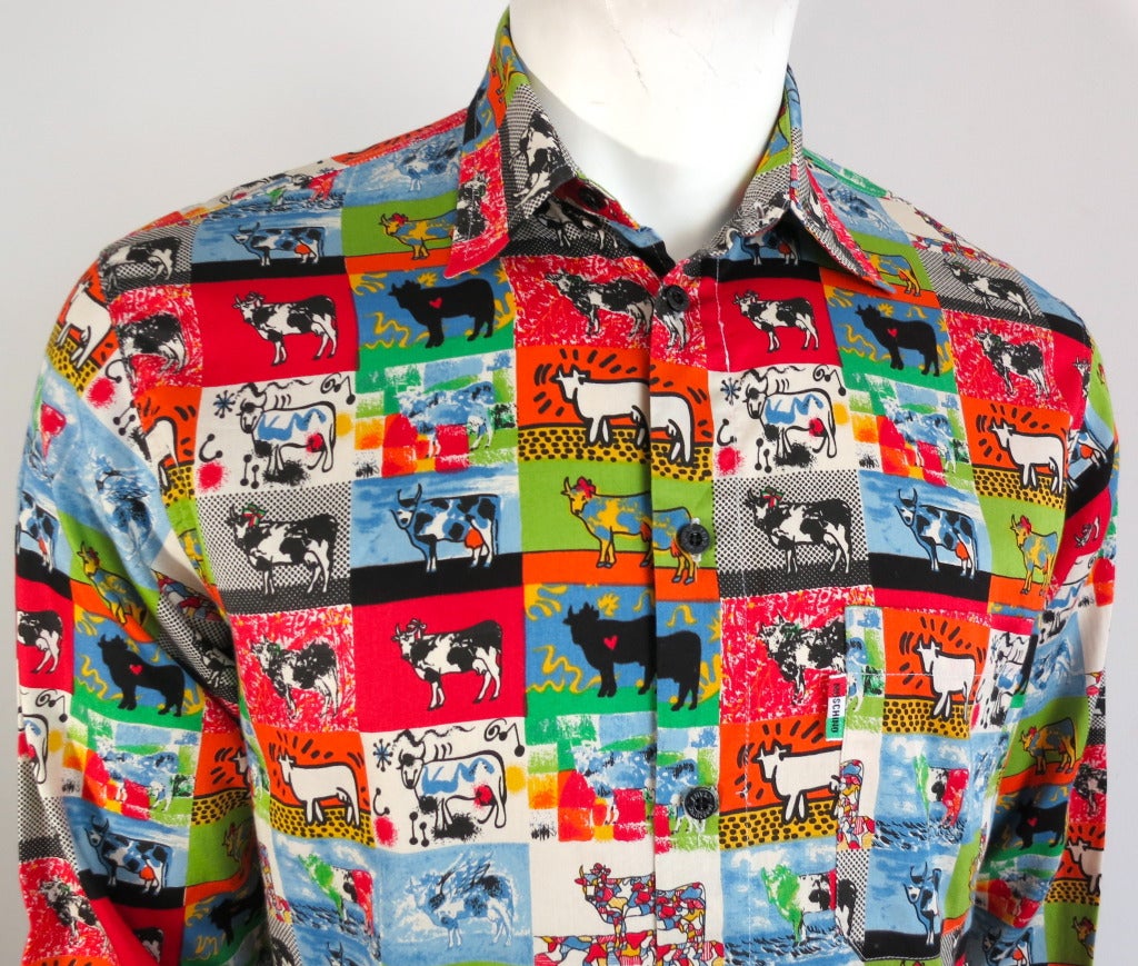 Vintage MOSCHINO 1980's era, multi-artist cow shirt in the styles of Haring, Matisse, Miro, Lichtenstein, etc.  

Colorful printed shirt with logo engraved black button closures.

Left chest patch pocket with italian flag logo jacquard
