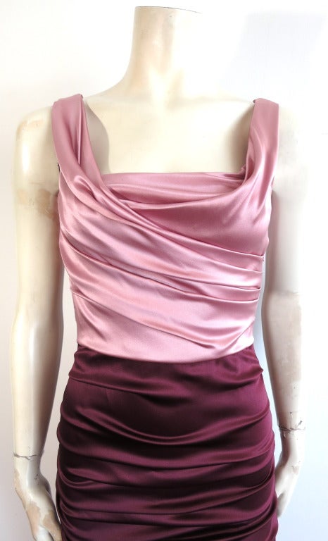 DOLCE & GABBANA Silk satin ruche detail cocktail dress.  Gorgeous rose pink top bodice with deep wine color bottom skirt.  Metal zipper entry at center back with logo engraved zipper pull ends.  

Stretch fabrication

Made in Italy

In