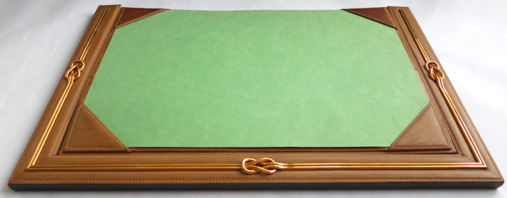 Vintage GUCCI ITALY Saddle leather & polished brass desk blotter.

Brown leather base with polished brass interlocking frame.  Removable green pad with leather corners.  Suede skin underside with logo patch.

Made in Italy, as