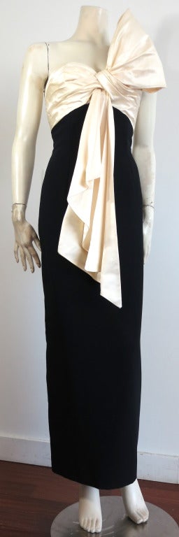 Vintage CHRISTIAN DIOR, Marc Bohan ivory satin and black crepe evening dress.

Dramatic, draped bow front with cascading front satin detail.  Ruché satin bodice with sweetheart style neckline.

Black crepé bottom dress with concealed center back