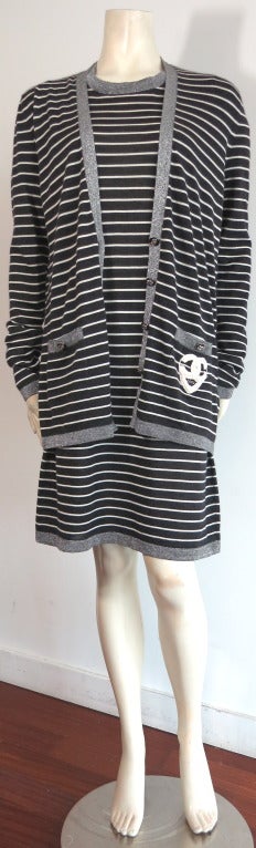 CHANEL PARIS Cashmere & silk 2pc. knit cardigan & dress set featuring signature striped pattern.

The luxurious, light weight knit fabrication has a dark charcoal gray base with ivory white stripes, and sparkly, metallic silver knit border, edge