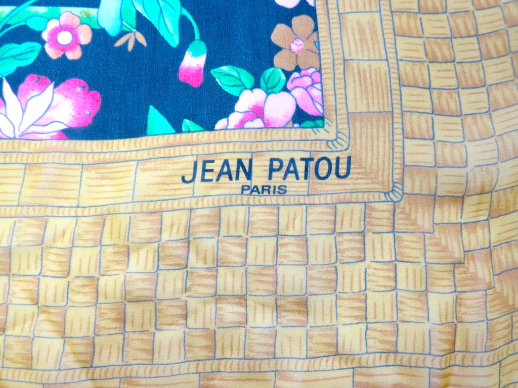 Vintage/Unused JEAN PATOU PARIS oversized 100% silk scarf/wrap featuring beautiful chinese floral artwork, with golden lattice printed border.

Semi-sheer silk fabrication with logo signature at lower left corner.

Made in Italy, as