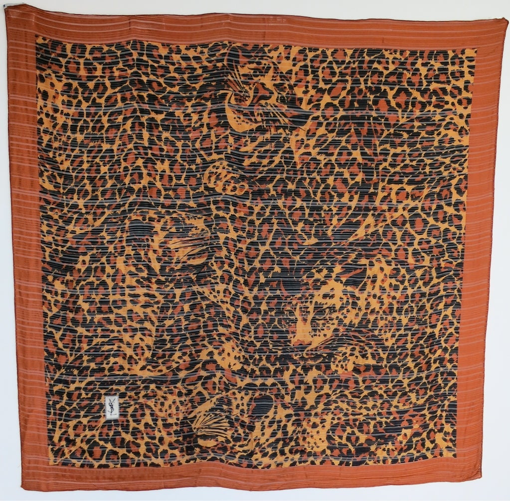 Vintage YVES SAINT LAURENT pure silk leopard print scarf with sheer stripe base.  

Tangerine boarder edge with signature YSL logo at lower corner of scarf.  

Signature four faced leopard within the greater leopard printed artwork

41