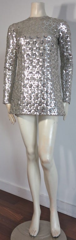 Vintage ADELE SIMPSON 1960's Metallic silver sequin rings micro-mini dress.

The base of the dress is made of pure silk organza in dove gray, and features long sleeves with a very short, 'micro-mini' length hem line...very Edie