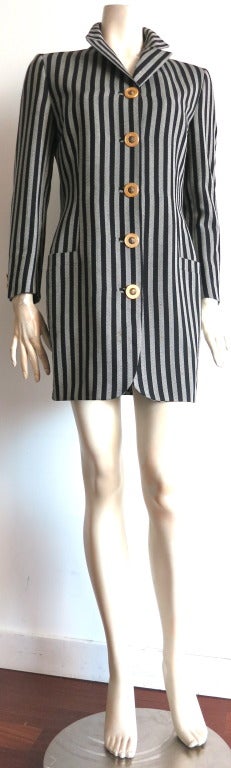 Vintage GIANNI VERSACE COUTURE Blazer style dress with oversized gold-finished, Medusa button closures at front and cuffs.

Wool herringbone fabrication in black with gray stripes.

Dual waist level pockets with tailored lapel.

Striped lining