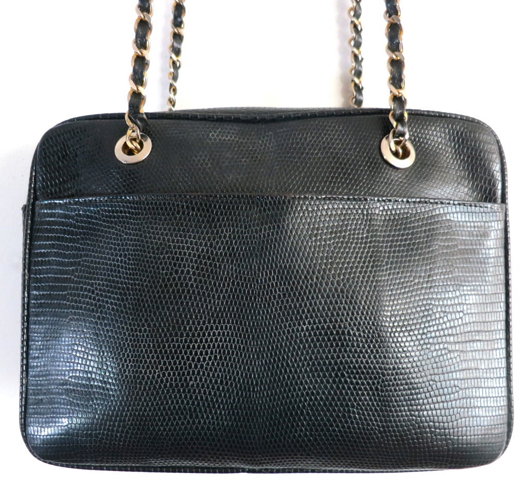 Vintage LANA OF LONDON 1980's black lizard skin, leather purse bag with gold-finished metal and leather lace shoulder straps.

The main bag features a functioning zipper top opening, and has oversized, polished gold finished eyelets at the top for