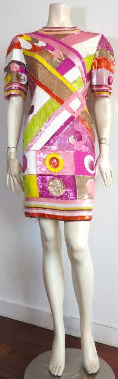 This amazing, vintage SAKS FIFTH AVE. dress features bold, colorful hand embellished sequins and beaded artwork that continues from front to back, as well as onto the sleeves.

The dress is quite heavily sequined and beaded, and the execution of