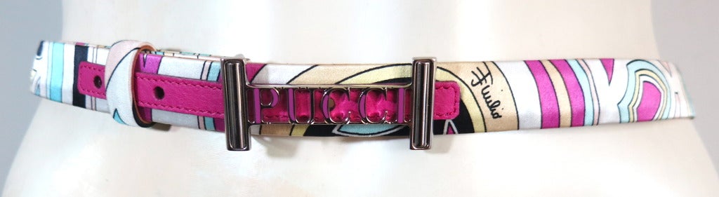 Excellent condition EMILIO PUCCI signature printed silk & leather belt.  

Multi-color, geometric signed print with large metal 'PUCCI' front hardware.

Leather base belt with printed silk top face.  Magenta leather trim on front face at