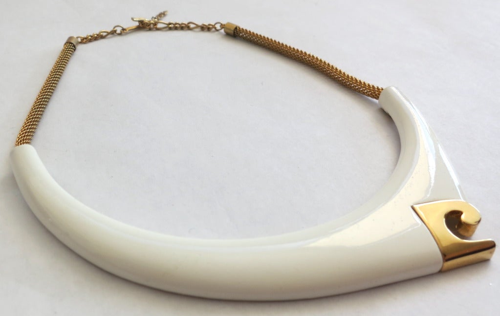 Vintage PIERRE CARDIN necklace.

The necklace was created by Pierre Cardin in the 1970's, and is engraved with signature at the reverse.

The epitome of mod style, this great condition necklace features an ivory enamel front crescent with