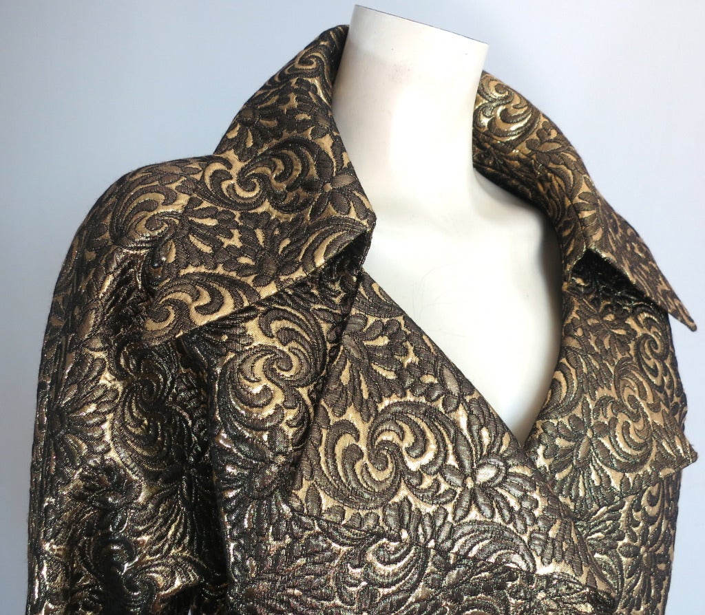 Mint condition James Galanos Metallic brocade blouson jacket.

This gorgeous jacket was created by James Galanos during the 1970's.

This ultra-lux, golden brocade jacket features an arabesque floral jacquard, and is a true metallic, double