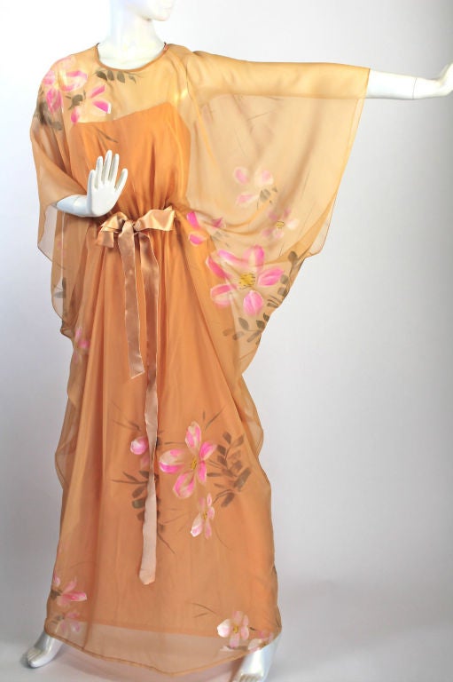 Unworn, vintage MALCOLM STARR Hand-painted silk floral caftan dress.

The dress was designed by MALCOLM STARR in the late 1960's to early 1970's.

This beautiful dress is a one-peice both the outer caftan and the under dress sewn together at the