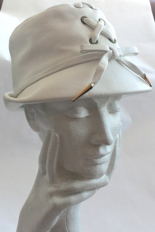 Excellent condition YVES SAINT LAURENT White leather 'Safari' hat.

The hat was designed by Yves Saint Laurent in the 1970's.

Soft, white leather fabrication with cross-lacing, and metal grommet details along the center, front seam