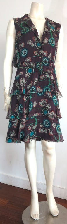 Gorgeous CHANEL PARIS Silk chiffon dress featuring lovely logo medallion, botanical style printed artwork in deep aubergine ground, with jade green, teal, and orange accent.

The dress features a fold-over, double-layred blouson back panel with