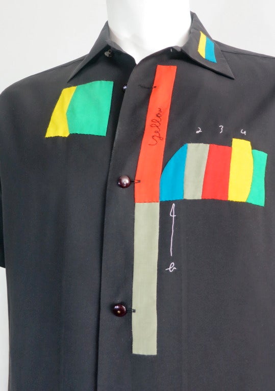 Great condition MATSUDA geometric applique hand-embroidered shirt.

The shirt was designed by Mitsuhiro Matsuda in Japan during the early 1990's.

The solid black, silky fabric shirt features hand stitched, inset, multi-color appliques with