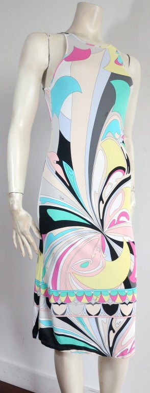 Excellent condition EMILIO PUCCI geometric stretchy tank dress.

Signature, multi-color geometric printed artwork with engineered border detail at bottom hem. Signed 'Emilio' throughout the artwork.

Keyhole style back with logo engraved pearl