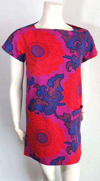 BIBA Floral printed shift dress in red, blue, and purple.  Fully lined with gusset shoulder detail construction, and zippered side slit detail at the wearer's left side seam.  Dual waist level front pocket detailing