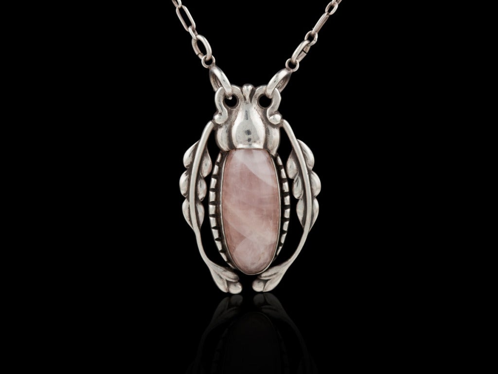 An Ornate Georg Jensen Pendant with a large rose quartz stone, design #18 by Georg Jensen.
Measurements are
Pendant: 1 7/8