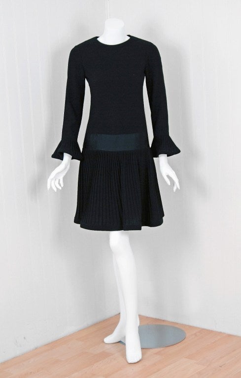 Spectacular late 1960's Pierre Cardin drop-waist mod dress in a rich fully-lined black wool-crepe. In 1951 Cardin opened his own couture house and by 1957, he started a ready-to-wear line; a bold move for a French couturier at the time. The look
