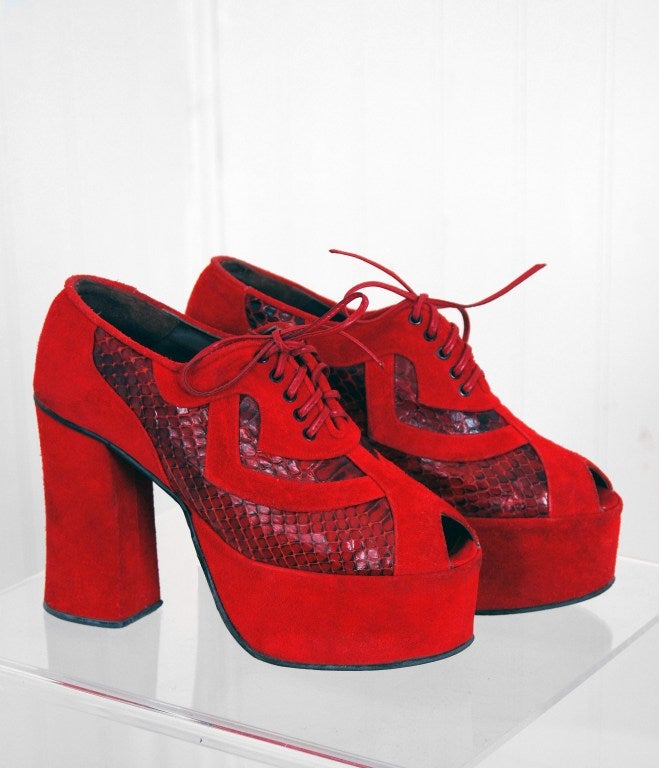 Sensational 1970's sky-high platform shoes in the most beautiful ruby-red color! I love the lace-up ties and peep-toe design. A disco re-interpretation of the famous 1940's platform! These shoes will leave you speechless.

Measurements
US size: 6