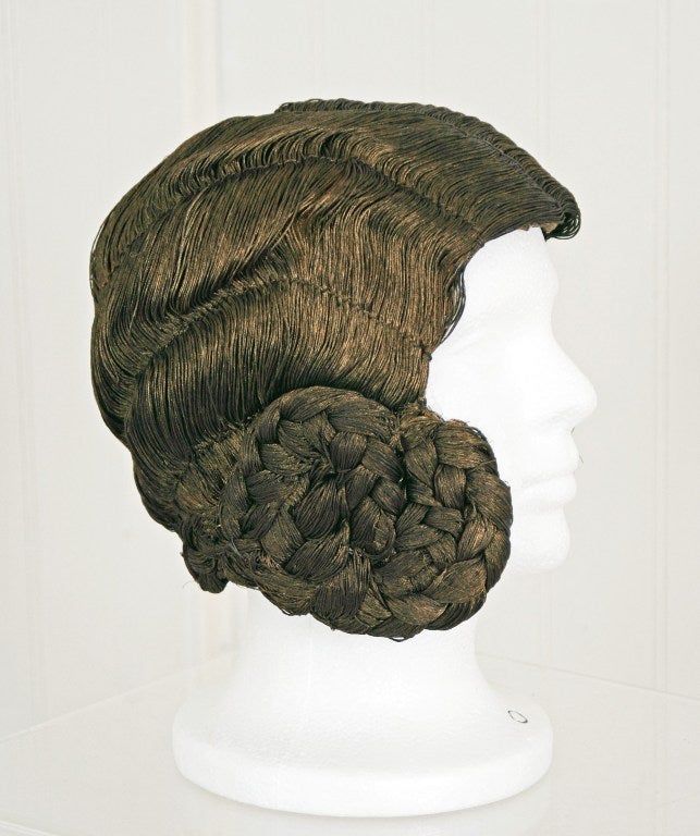 The finest and most elegant of wig cloches to be found, woven of metallic-gold bullion flossed “hair”. This is an extremely rare high-style wig cloche; a mark of sophistication. The cloche is woven into the shape of a classic 1920's hairdo- complete