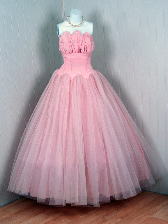 Breathtaking 1950's champagne-pink princess gown fashioned from sculpted taffeta and net-tulle. This party dress is so fresh and youthful with its vibrant color and pearl-drop beadwork! This beauty combines a fetching, girlish appeal with a woman's