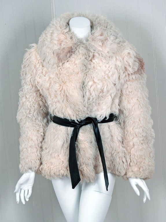 This stunning 1960's Mongolian genuine-fur finely shaped jacket will be your statement piece all season long. It has just a touch of curl and a natural difference in colors, ranging from ivory to taupe. I adore the over-sized collar and original